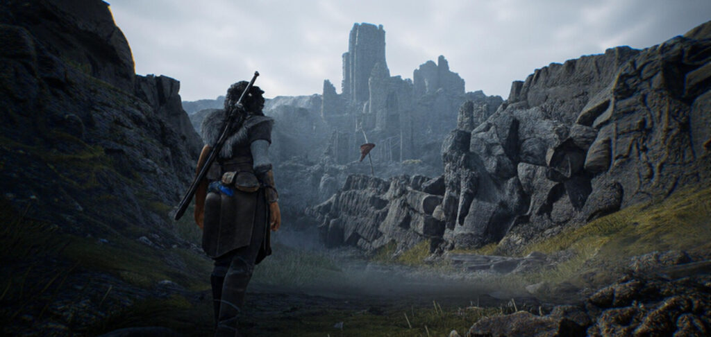 A lone warrior stands with their back to the viewer, equipped with a sword and shield, gazing toward a distant, ruined castle nestled between rugged, rocky cliffs under a cloudy sky. The landscape is barren with patches of grass, evoking a desolate, mystical atmosphere.